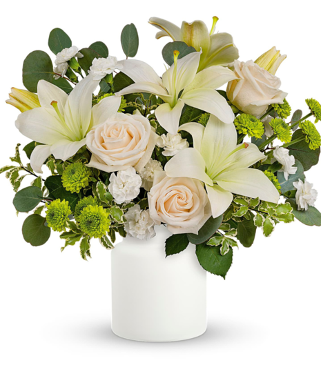 green and white flowers in a white vase 