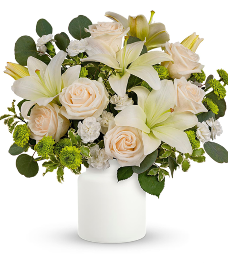 green and white flowers in a white vase 