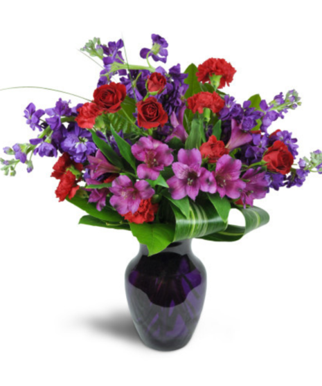 lavender and pink flowers in purple ginger vase